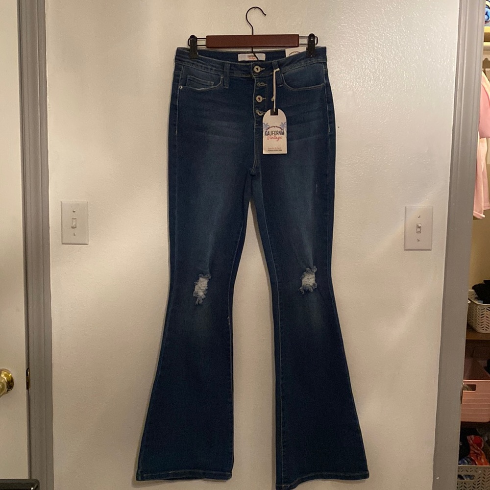 Button up, flared jeans. Distressed. Dark wash . New